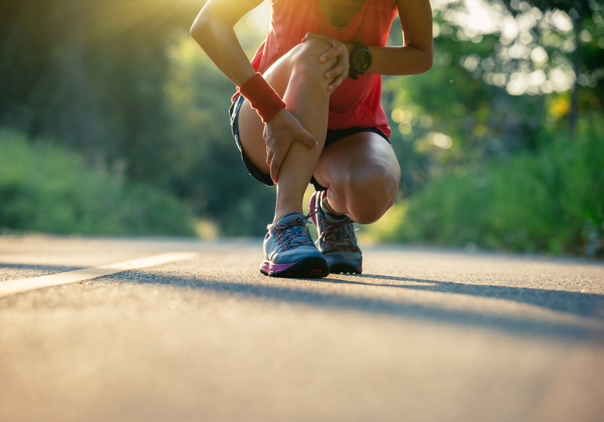 Woman runner got sports injury running on forest trail